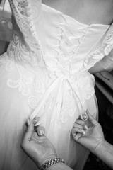 Close-up of groom's hand holding bride's wirst tender, flower, newlywed, church