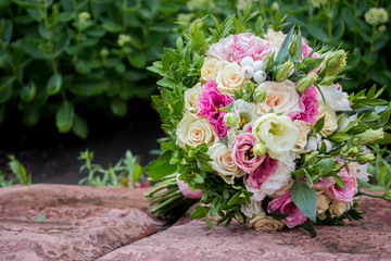 Close-up of groom's hand holding bride's wirst tender, flower, newlywed, church