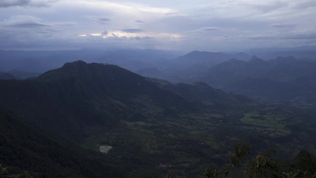 4K Day to night sunset timelapse over the steep wild mountains of antioquia's countryside, Colombia, with a storm on the horizon.