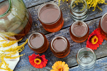 Fresh honey in glass jar on wooden background.
