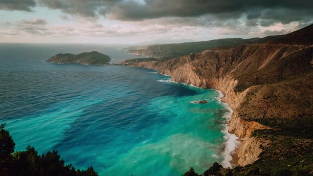 Beautiful bay with brown rocky limestone coastline and moving dramatic clouds on horizon, Assos, Kefalonia island, Greece 4k timelapse