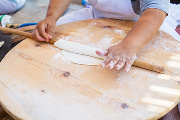 Pita bread with cottage cheese and greens. Preparing traditional bread on the street market.