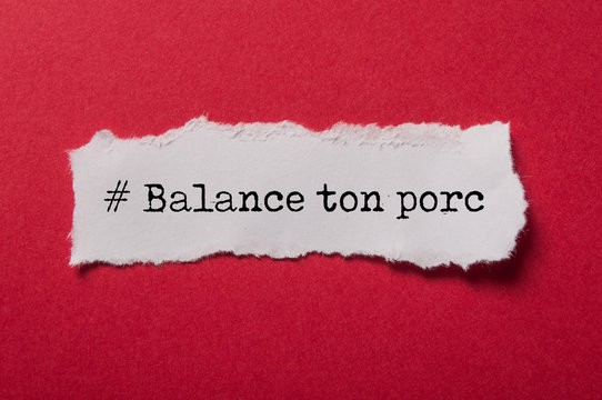closeup of white torn paper on red paper background with text in french - # Balance ton porc, traduction :  denounce your pig