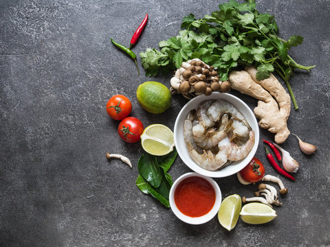 Traditional Thai food cuisine.  Various ingredients of Tom Yum spicy soup on black background. Thai food concept. Top view