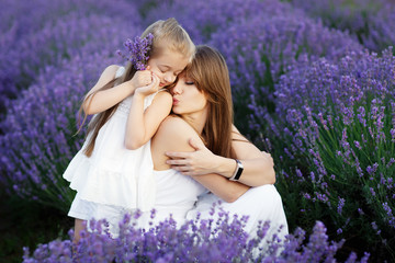 Mom and Daughter in the lavender field. Family love concept.