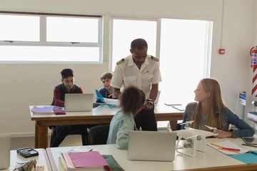 Pilot giving training about model aeroplane to students