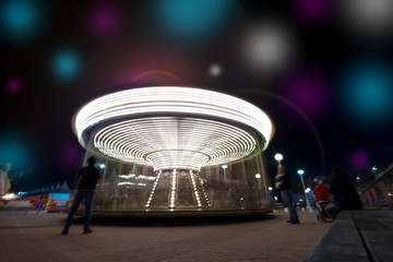 Abstract, long exposure shot of spinning Children's vintage Carousel at an amusement park in the...