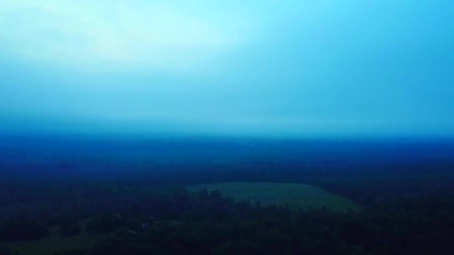 Misty morning above the forest in Ashville. Asending drone shot.
