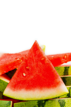 Sliced red watermelon on grey plate isolated.