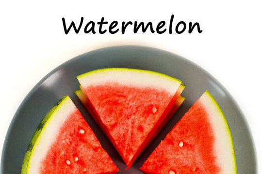 Sliced red watermelon on grey plate isolated. View from above.