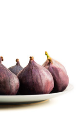 Fresh figs on grey plate isolated on white