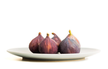 Fresh figs on grey plate isolated on white