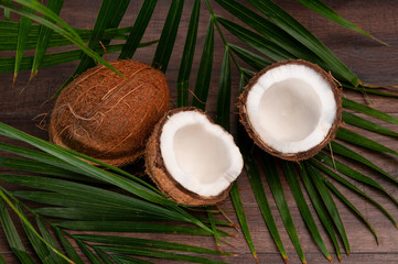 Fototapeta na wymiar Сoconut on a palm tree background. Coconut in a cut