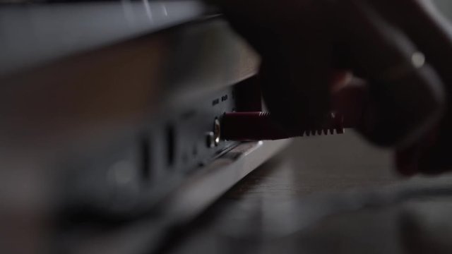 Music producer pluging in audio stereo jack cables