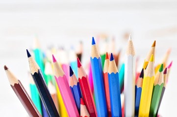 Colored pencils in pencil case  on wooden background.

