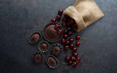 Homemade sweet cupcake and cherry background.