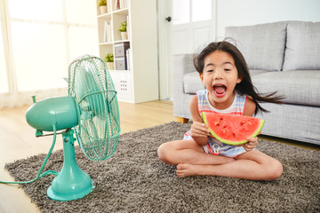 lovely girl laughing and holding a sliced melon.