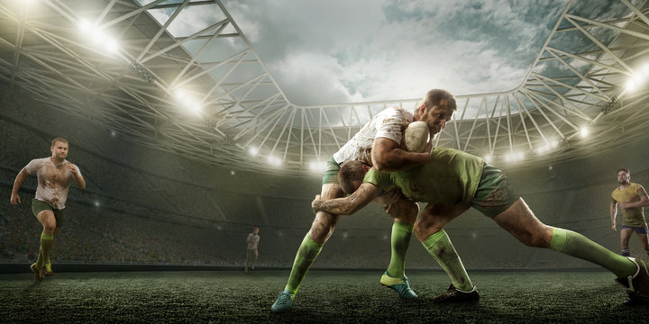 Rugby players fight for the ball on professional rugby stadium - Powered by Adobe