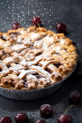 traditional cherry pie with powdered sugar.