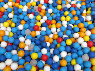 Multi-colored plastic balls on kids playground. Balls for fun and jumping, colorful festive background