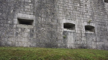 Port firing holes in Military fort built of stone from 19th century, Fort Kluze in Bovec, Slovenia was built by Austrian Army to guard a mountain pass in the Alps against Italian and French armies