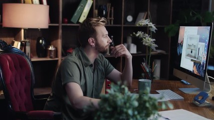 Male graphic designer using computer program to develop interior design in project. Architectural designer working on creative project in office. Creative designer at work