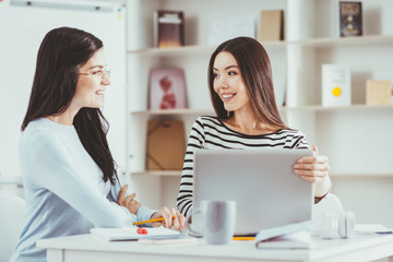 University students. Positive young students looking at each other while working together on a project