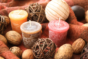 Autumn decor with candles on the background in a cage