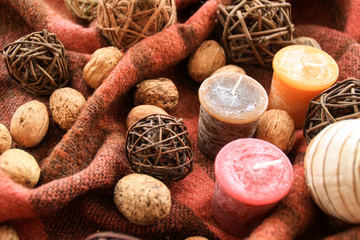 Autumn decor with candles on the background in a cage