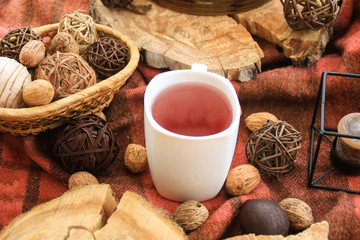 Autumn wooden decor with white cup of tea  and candles.