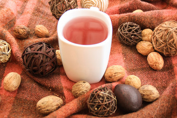 Autumn decor with white cup of tea.