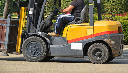 Forklift works on the city street