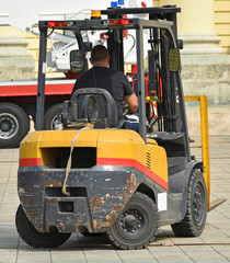 Forklift works on the city street