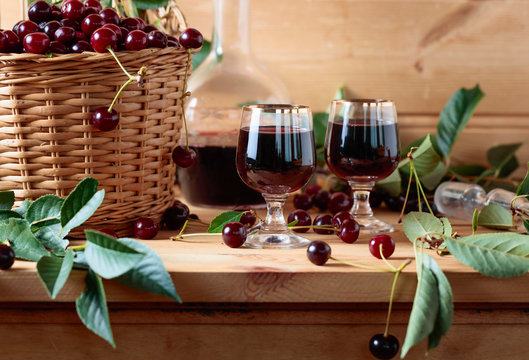 Cherry wine or liquor and ripe juicy cherries.