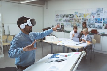 Male executive using virtual reality headset