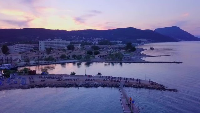Greece, Corfu Island, drone footage of a beautiful sunset over Messonghi Beach. Orbit Shot Right.