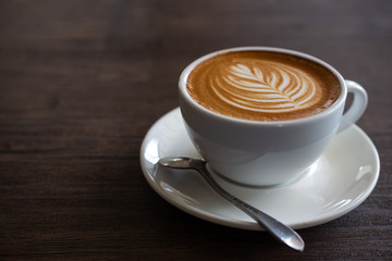 Cup of coffee latte on wood