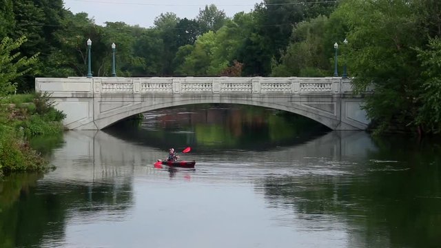 A kayaker takes advantage of the rising Yahara River to get close to a bridge ahead of flooding in Madison, WI.