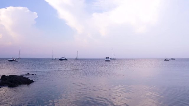 Yachts and boats are resting in the bay of Spanish island. 
Summer, beautiful afternoon.