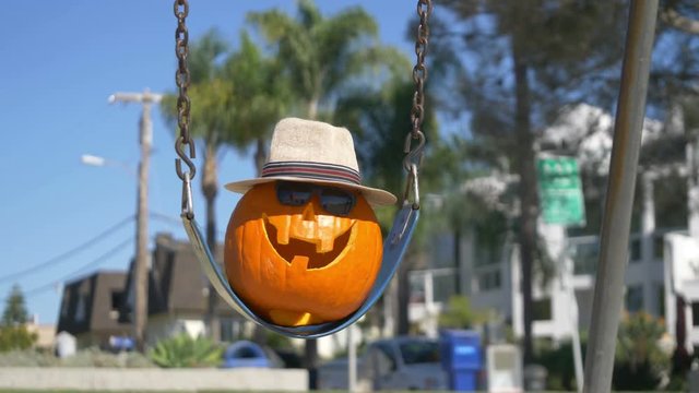 Happy Halloween pumpkin on the swing in 4K Slow motion 60fps