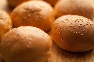 background of homemade buns with sesame seeds for hamburgers. made at home bread. natural product.