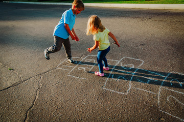 kids playing hopscotch on playground, outdoor activities