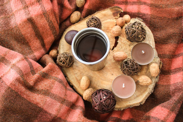Autumn wooden decor with white cup of tea  and candles.