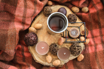 Fototapeta na wymiar Autumn wooden decor with white cup of tea and candles.