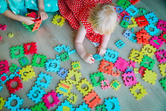 kids playing with puzzle, learning numbers and shapes
