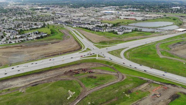 Aerial drone footage of highway intersection with beautiful city landscape and infrastructure. 4k.