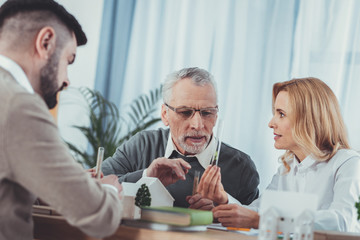 New approach. Low angle of ambitious three colleagues carrying vials and having discussion