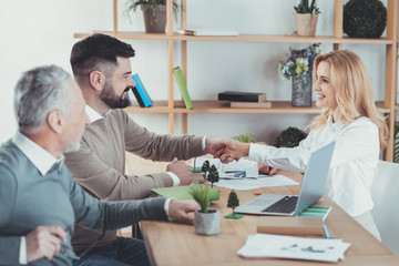 Future in hands. Jolly three colleagues having meeting and smiling