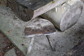 Old wooden table and chair in the forest.