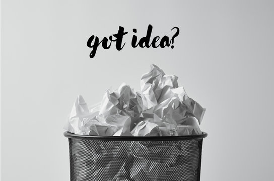 close-up shot of office trash bin with crumpled papers isolated on white with "got idea?" lettering